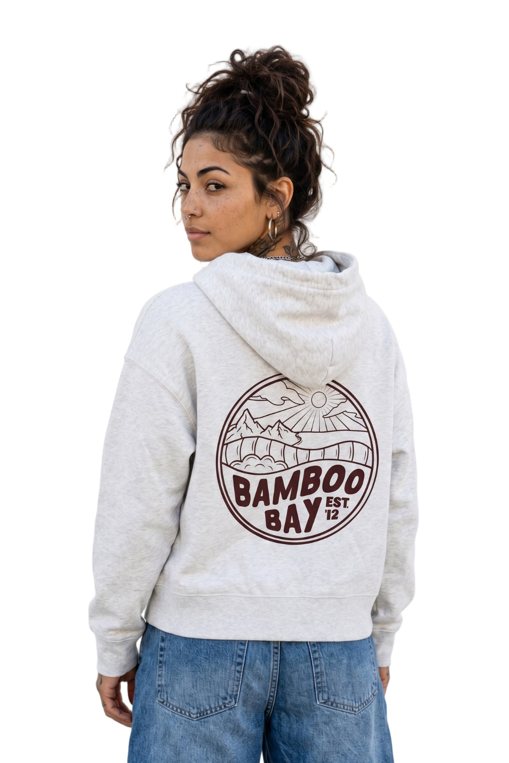Woman wearing a white hoodie with 'Bamboo Bay' logo on the back, standing against a white background.