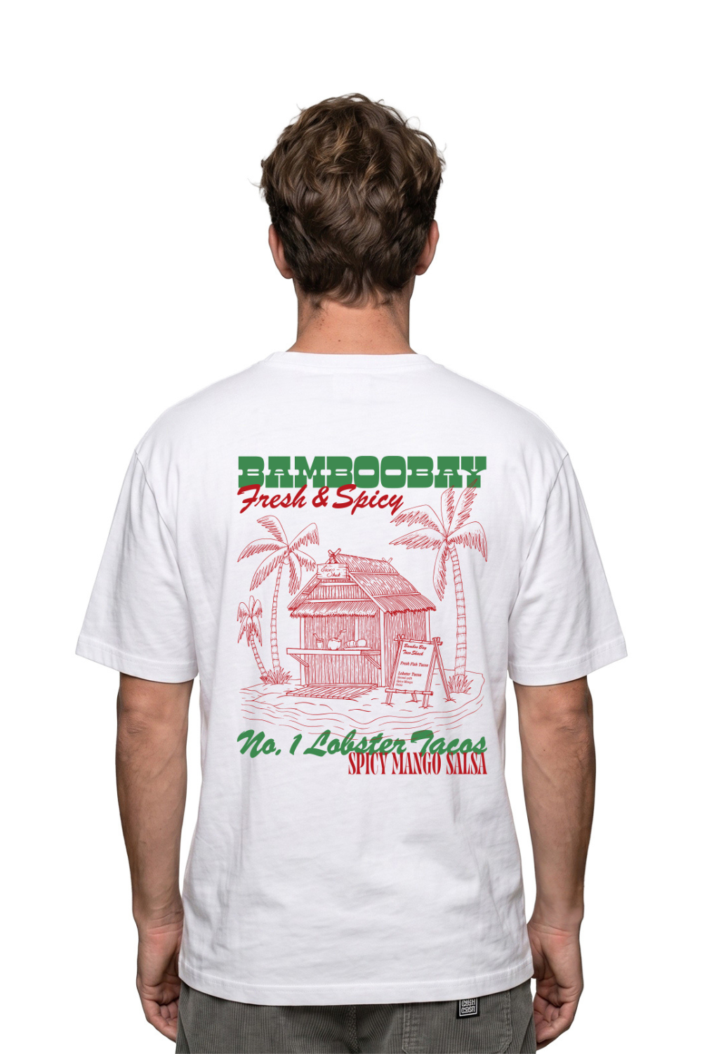 Person wearing a white t-shirt from with graphic Taco shack print on the back